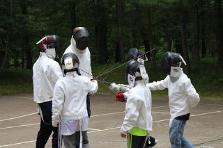 Children participating in fencing instruction at a Minnesota summer camp