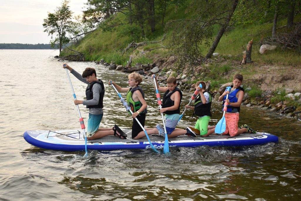 Children participating in unique seasonal activities at a co-ed summer camp in Duluth, MN