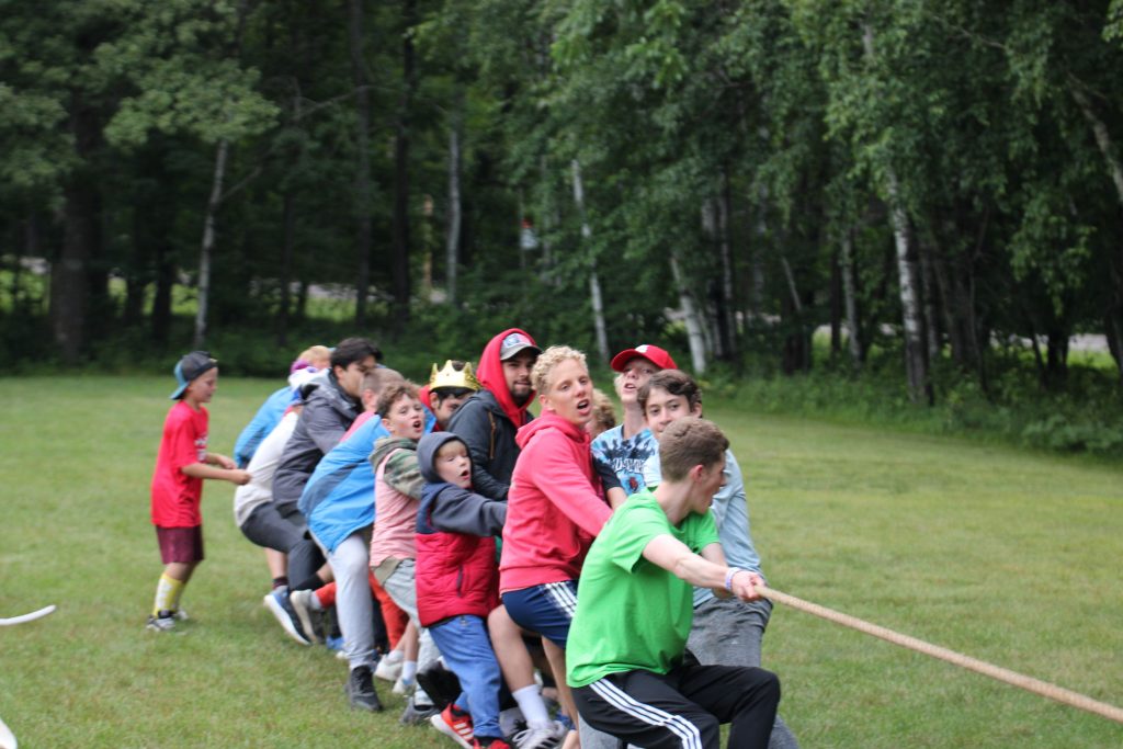 Children participating in outdoor adventure activities at summer camp