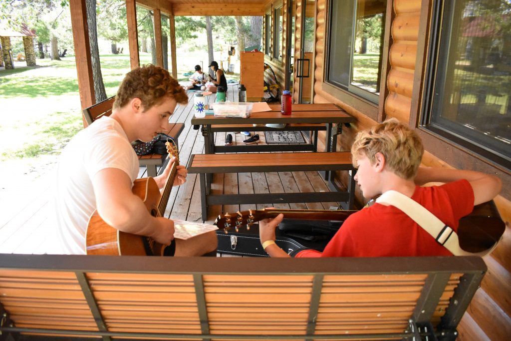 learning to play guitar at Camp Foley