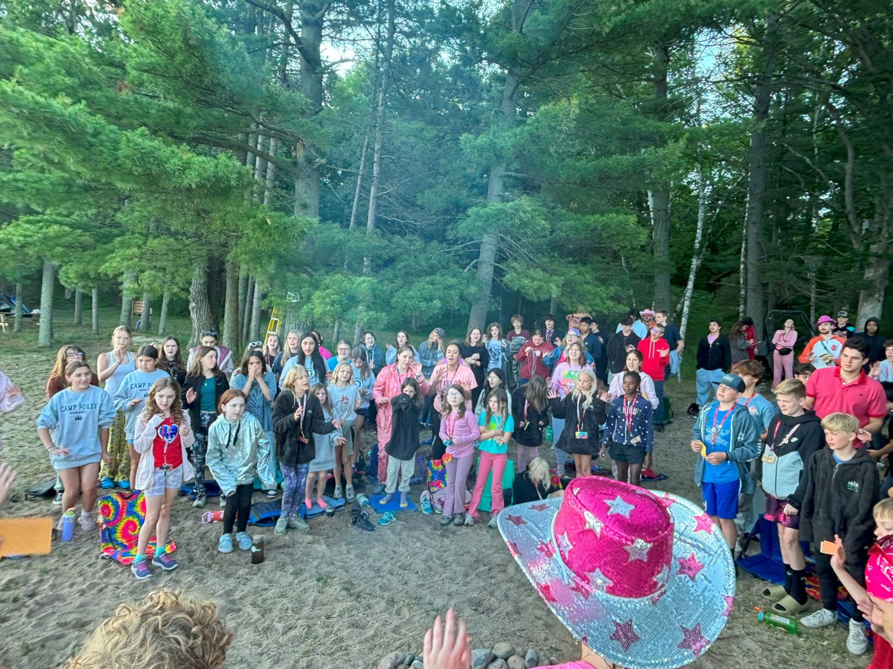 a group of children sing a song on a beach at Camp Foley 