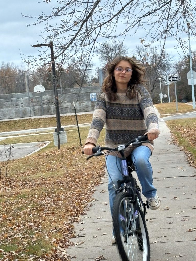 A girl rides her bike 