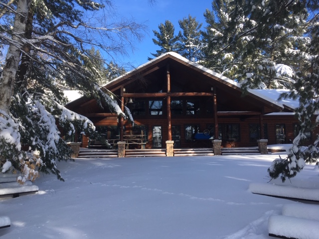 The Camp Foley dining hall covered in snow pictured at a distance 