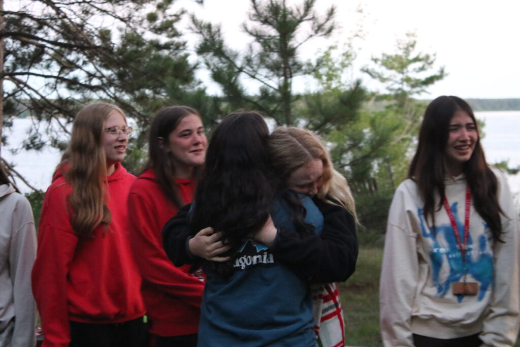 Girl's embrace at the Camp Foley Friendship Campfire 