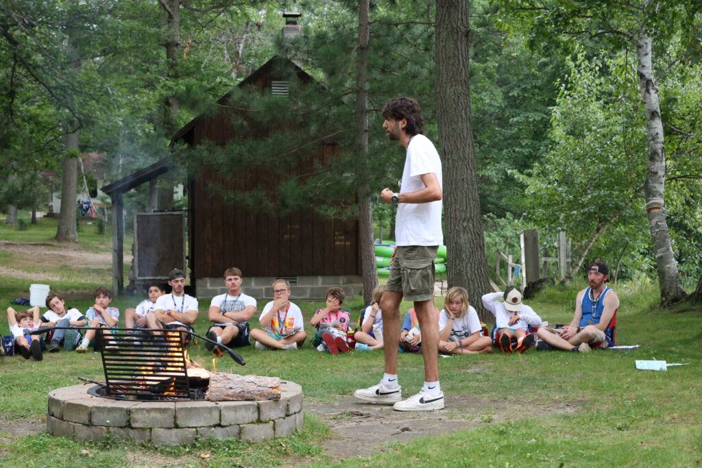 A Camp Foley counselor leads a discussion in front of a group of boys
